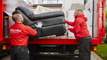 Junk King Service Man Loading Sofa onto a Junk King Truck